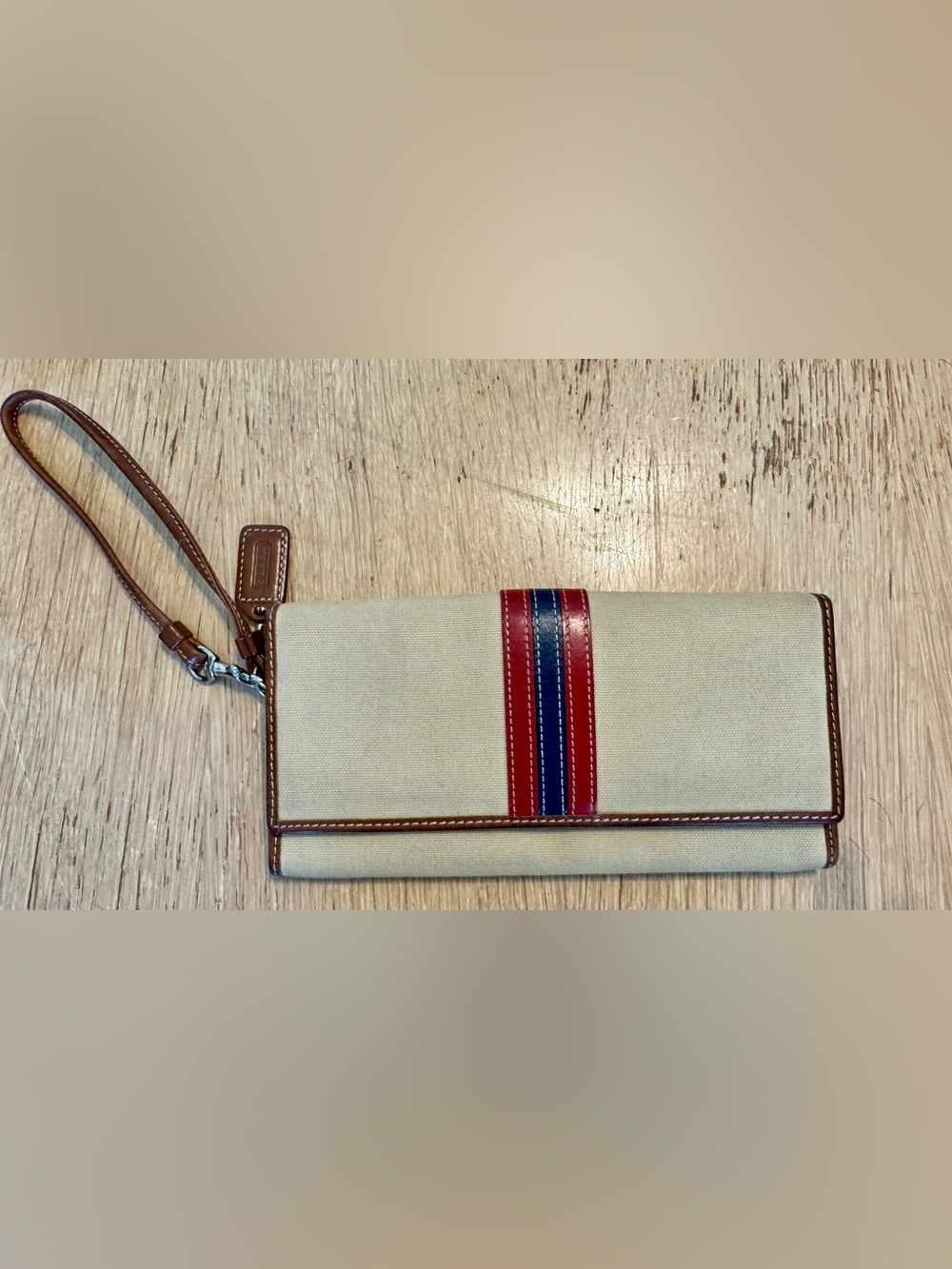 Coach Canvas Zip Wallet with Brown Leather Trim and Red/Blue Accent.
